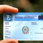 Persona che tiene in mano una tessera sanitaria