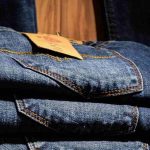 Jeans piegati con etichetta su scaffale di un negozio